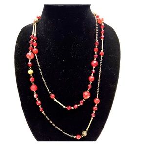 Long red beaded and brass tone necklace